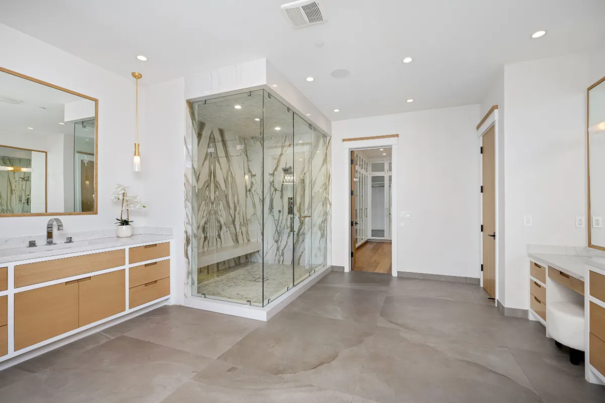 Bathroom remodeling project in Los Angeles with luxury walk-in glass shower, marble-look tile, double vanity, and spa-style finishes