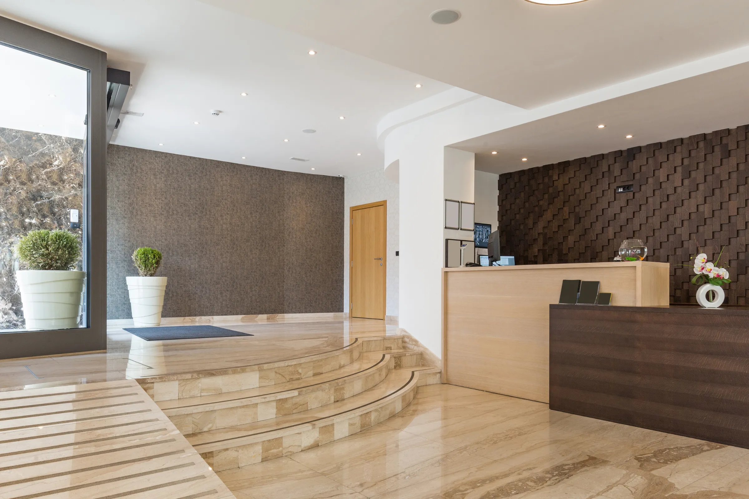 After commercial remodeling project in Los Angeles with modern lobby renovation, brighter reception area, updated flooring, improved lighting, clean walls, and professional customer-facing business space