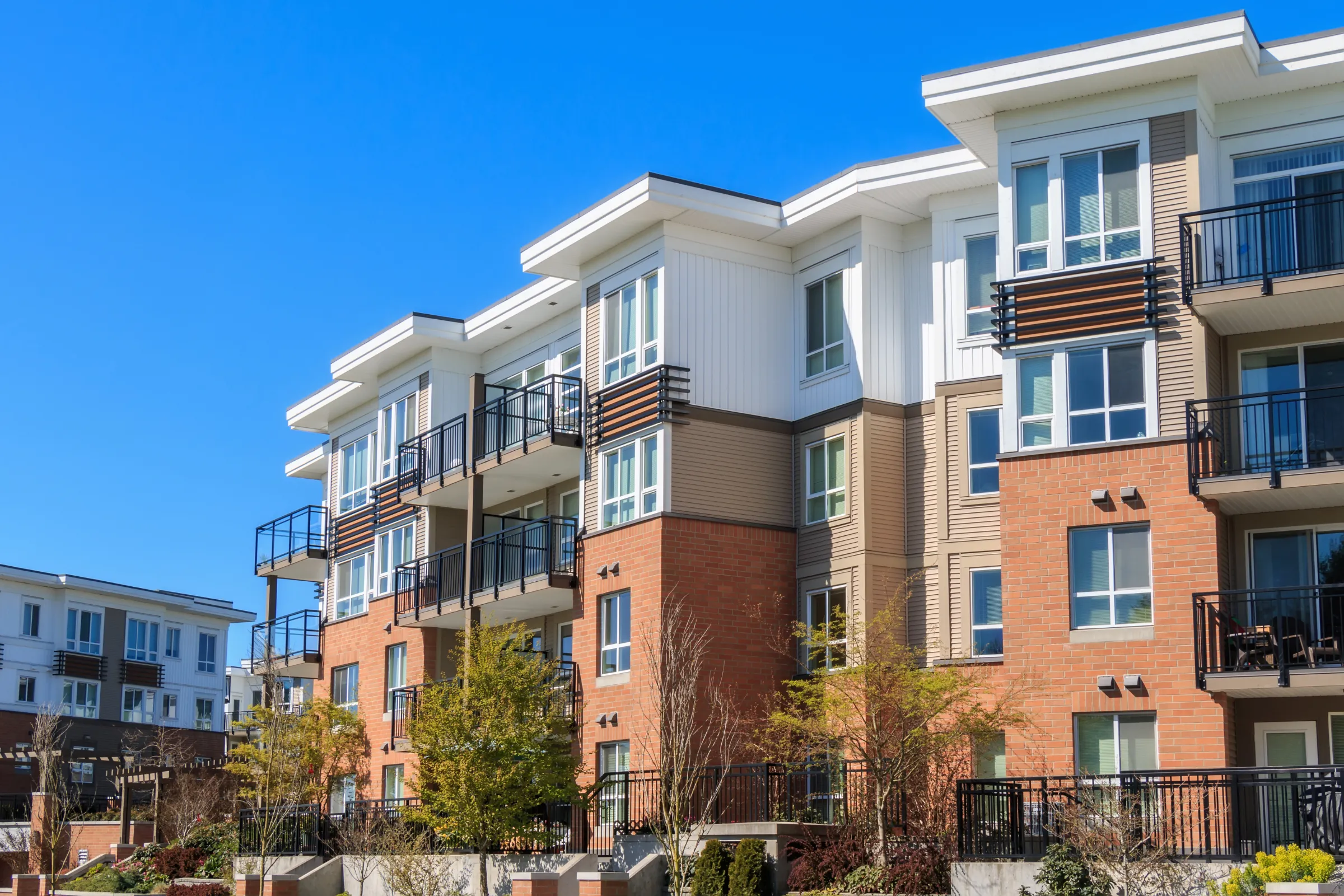 Condo remodeling in Los Angeles for a multi-unit residential property with modern exterior, balconies, shared building areas, and community living space