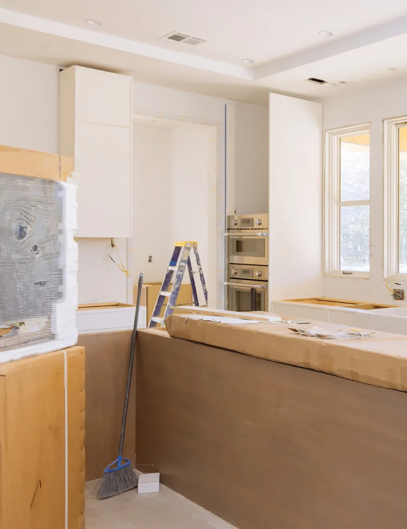Full home remodeling in Los Angeles with kitchen renovation in progress, cabinet installation, appliance wall setup, island preparation, and interior construction work