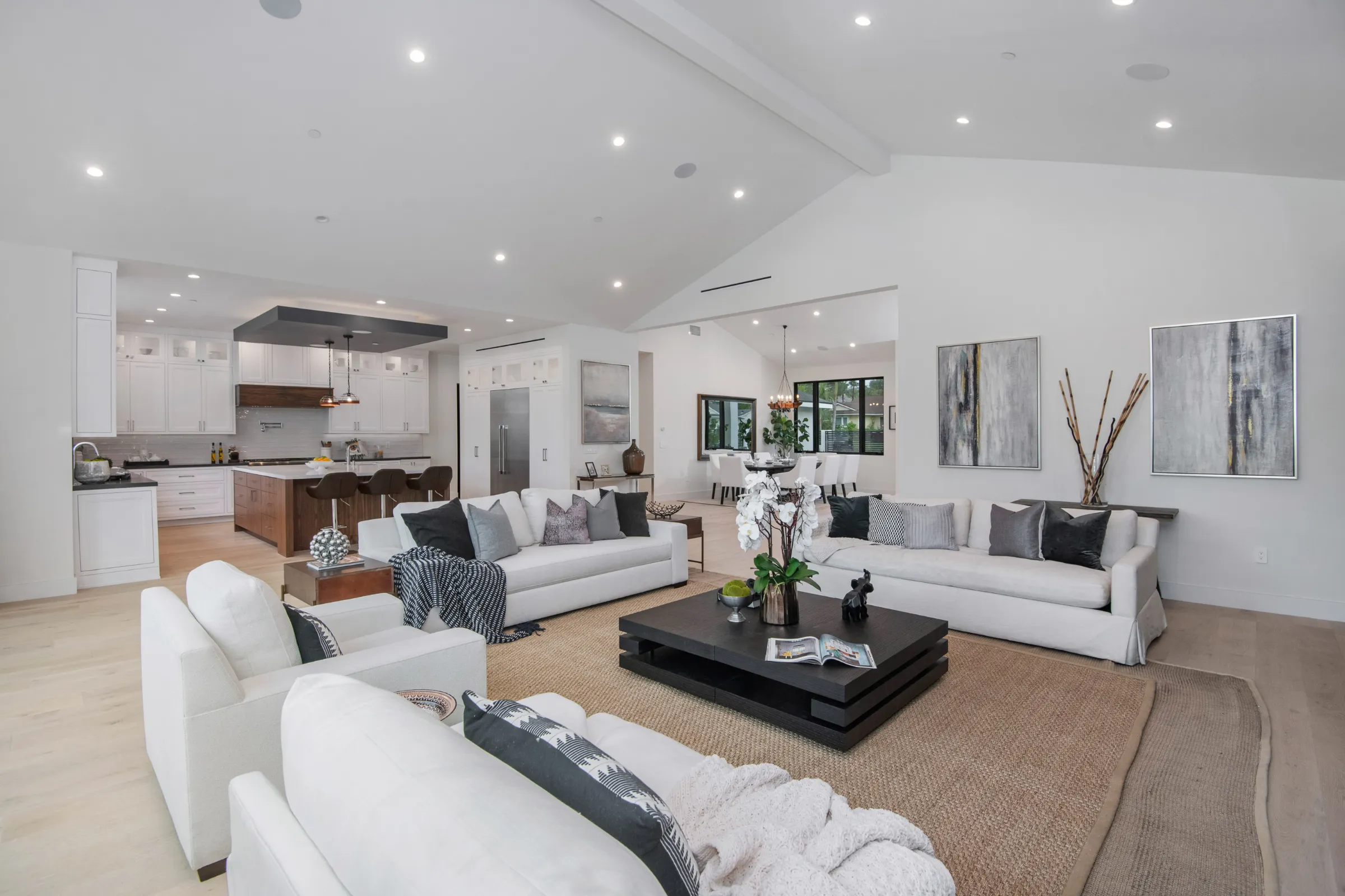 Completed full home remodeling project in Los Angeles with open concept living room, modern kitchen, vaulted ceiling, recessed lighting, and bright interior design
