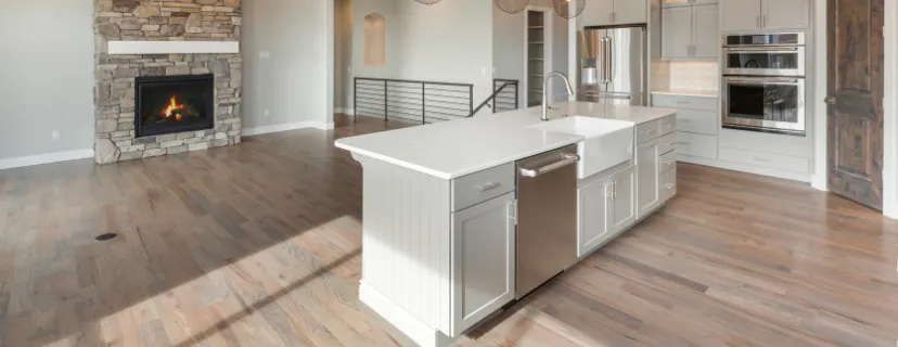 Completed kitchen remodeling project in Los Angeles with open concept layout, large island, updated cabinetry, modern appliances, and hardwood flooring