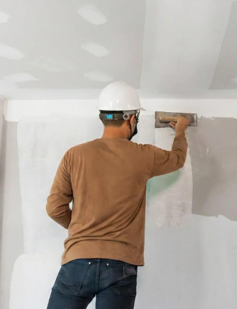 Los Angeles home remodeling contractor applying drywall finish during interior wall renovation and full home improvement project
